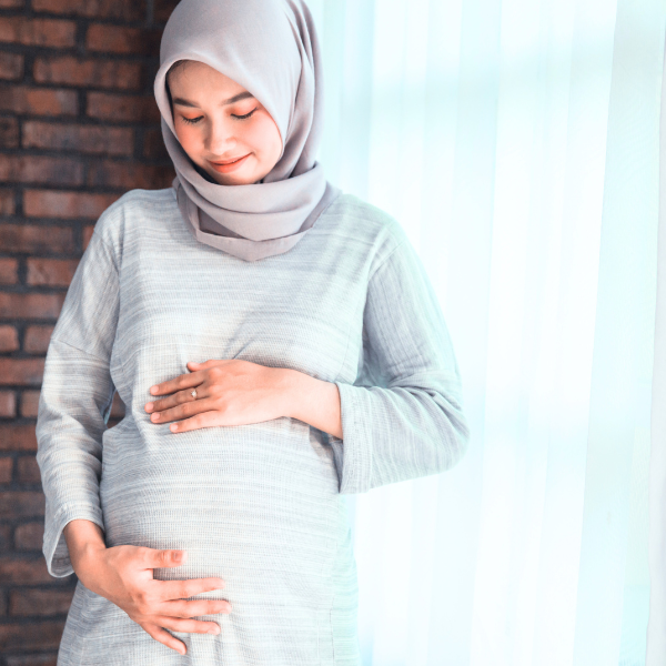 Woman holding her pregnant stomach